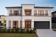 a white two story house with lots of windows