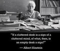 an old woman sitting at a desk with books on it and a quote above her