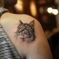 a woman with a cat tattoo on her shoulder