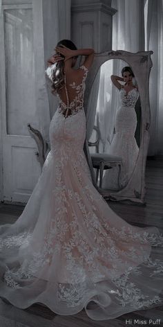 a woman in a wedding dress looking into a mirror