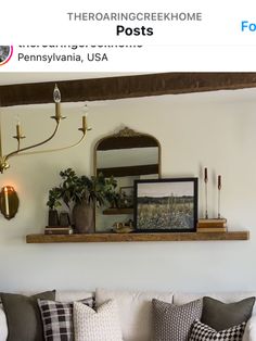 a living room with couches, pillows and pictures on the wall above them is featured in this post