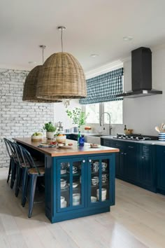 a kitchen with blue cabinets and an island