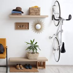 there is a bike mounted to the wall next to a shelf with shoes on it