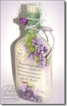 a glass bottle with purple flowers and a poem on the lid that says, i love you