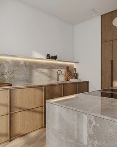 a modern kitchen with marble counter tops and wooden cabinetry, along with stainless steel appliances