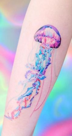 a colorful jellyfish tattoo on the arm