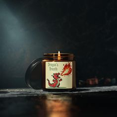 a candle with a dragon's breath label on it sitting on a counter top