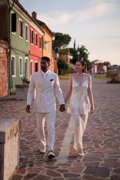 Bride wearing a Danielle Frankel wedding dress walking the streets of Italy with her groom.