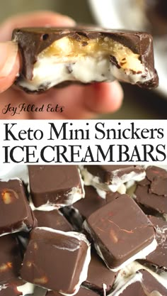 a close up of a person holding a chocolate ice cream bar with the words keto mini snickkers on it