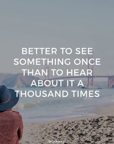 a person sitting on the beach looking out at the ocean