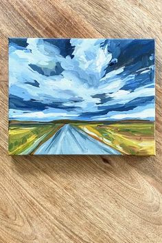 an acrylic painting of a road leading to the sky with clouds above it