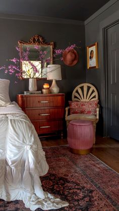 a bedroom with gray walls and pink accents