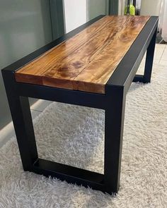 a wooden table sitting on top of a white rug