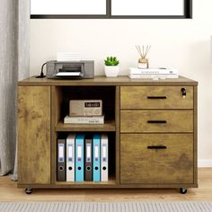 a wooden cabinet with books and printer on top