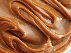 a close up view of chocolate frosting with swirls on it's surface