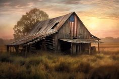 an old barn with the american flag painted on it's side in a field