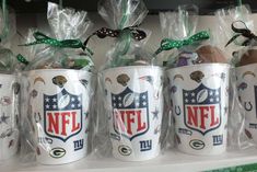 nfl coffee cups are wrapped in plastic and tied with green bows