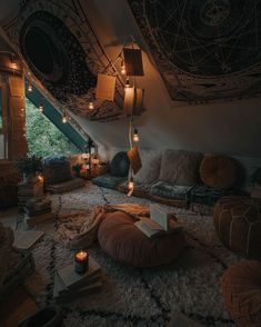 a living room filled with lots of furniture and lights on the ceiling over it's windows