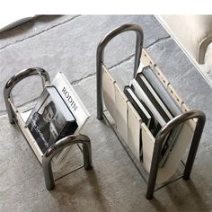 two metal magazine racks sitting on top of a floor next to each other with magazines in them