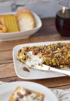 a piece of cake sitting on top of a white plate next to some crackers