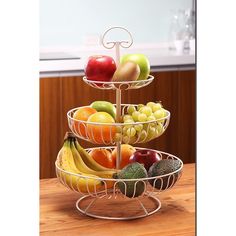 three tiered fruit tray with apples, bananas and avocados