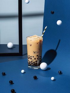 a drink in a tall glass on a blue table