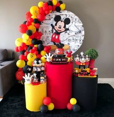 a mickey mouse birthday party with balloons and decorations