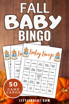 a baby shower game with pumpkins and leaves on it, in front of a wooden background