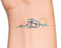 a small wave tattoo on the wrist