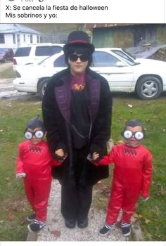 an older woman standing next to two small children in red jumpsuits with googly eyes