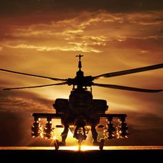 a helicopter is flying in the sky at sunset with clouds and sunbeams behind it