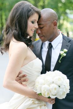 a bride and groom pose for a wedding photo