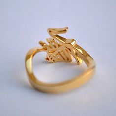 "Simply stunning! Beautiful handcrafted 14k Gold two name ring. This lovely custom made ring is perfect for that special and crazy relationship between the 'two-of-you'. Husband-wife, mother daughter, best friends, brothers, sisters and all of your loved ones - to own or to gift :) Important dates/coordinates can also be made. We will send a drawing before starting the manufacturing process so you know what it will look like. SENDING AS A GIFT We would be happy to send your gift directly to the Yellow Gold Wedding Rings With Custom Name, 14k Gold Name Ring For Wedding, Unique Gold Engraved Promise Ring, Yellow Gold Engraved Name Ring For Wedding, Unique Engraved 14k Gold Ring For Wedding, Gold Wedding Rings With Name Detail, Unique Engraved Yellow Gold Wedding Ring, Gold Wedding Rings With Name, Fine Jewelry Name Ring For Wedding