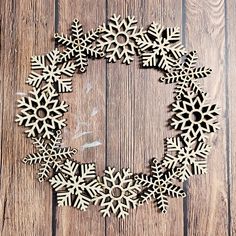 wooden snowflakes are arranged in a circle on a table