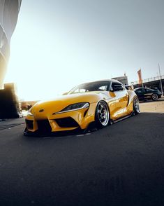 a yellow sports car parked in front of a building