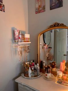 there is a vanity with many items on the counter and in front of a mirror