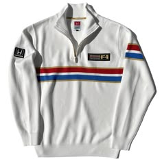 SSS-13w Dark blue knitted sweater with red, white, blue and gold decoration. Period correct authentic Honda and F1 team patches. Super-soft cotton/acrylic blend (45%/55%) Inspired by the uniforms worn by Honda F1 Racing Team engineers during the 1986 Formula 1 season. The mighty turbo V6, Honda RA 166E engine produced more than 1000+ hp in qualifying trim, winning 9 out of 16 races delivering Honda and their Grove-based partners the World Constructor's Championship in 1986. All our merchandise i Vintage Sports Outfit, Vintage F1 Merch, F1 Clothing, F1 Merchandise, Blue Knitted Sweater, Honda F1, Vintage Culture, Streetwear For Men, Team Jackets