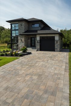 a large brick driveway in front of a house