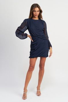 Sophisticated, exclusive, and elegant, this long-sleeved mini dress features intricate ruching for a truly stunning and luxurious look. Perfect for any occasion, this dress will make you feel like a work of art, combining fashion and luxury in one stunning piece. Round neckline Balloon sleeved Dress silhouette Mini dress length Runched design Fabric Contents: 100% Polyester Lining: 100% Polyester Model wears small sizeModel's height 5'9" Ruched Long Sleeve Mini Dress For Night Out, Elegant Long Sleeve Dress With Gathered Sleeves For Fall, Fall Evening Long Sleeve Dress With Gathered Sleeves, Long Sleeve Ruched Mini Dress For Evening, Chic Draped Mini Dress For Fall, Chic Ruched Long Sleeve Dress For Date Night, Long Sleeve Cocktail Dress With Gathered Sleeves, Cocktail Dress With Gathered Long Sleeves, Cocktail Dress With Long Gathered Sleeves