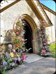 an old church with flowers growing out of it