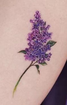 a tattoo with purple flowers on it