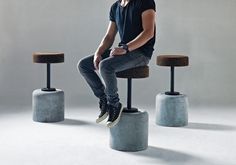 a man sitting on top of two stools