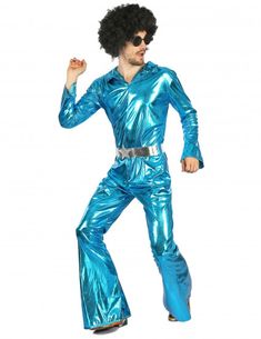 a man in a blue disco suit is posing for the camera with his fist up