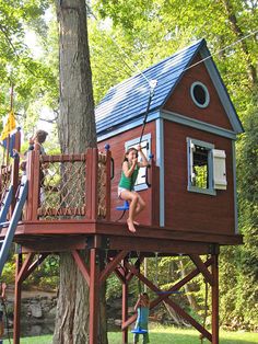 two children are playing in a tree house