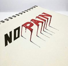 a spiral notebook with the word pray written in red and dripping paint on it, next to a pen