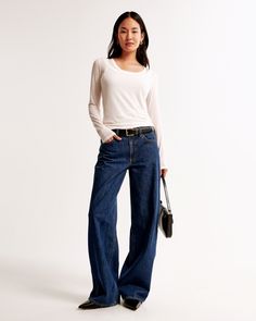 Our new classic ultra loose jeans in a dark marble wash with a clean hem. This fit features a 8.5” low rise, is relaxed at the waist and hips, and eases at the thigh into an ultra loose, full-length leg shape. We recommend buying your true size for a baggier fit. Size down for a closer fit. This jean is made from our lightweight rigid denim, a super soft authentic cotton fabric with no stretch. Dark Marble, Loose Jeans, New Classic, Dark Wash Jeans, Top Knot, Baggy Fits, Abercrombie Fitch, Low Rise, Womens Bottoms