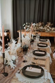 the table is set with black and white place settings