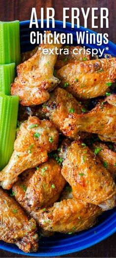 air fryer chicken wings with celery in a blue bowl on a wooden table