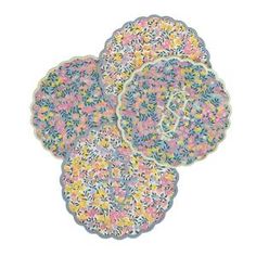 three colorful plates with floral designs on the top and bottom, all in different colors