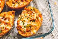 baked bread with cheese and vegetables in a glass dish on a wooden table, ready to be eaten